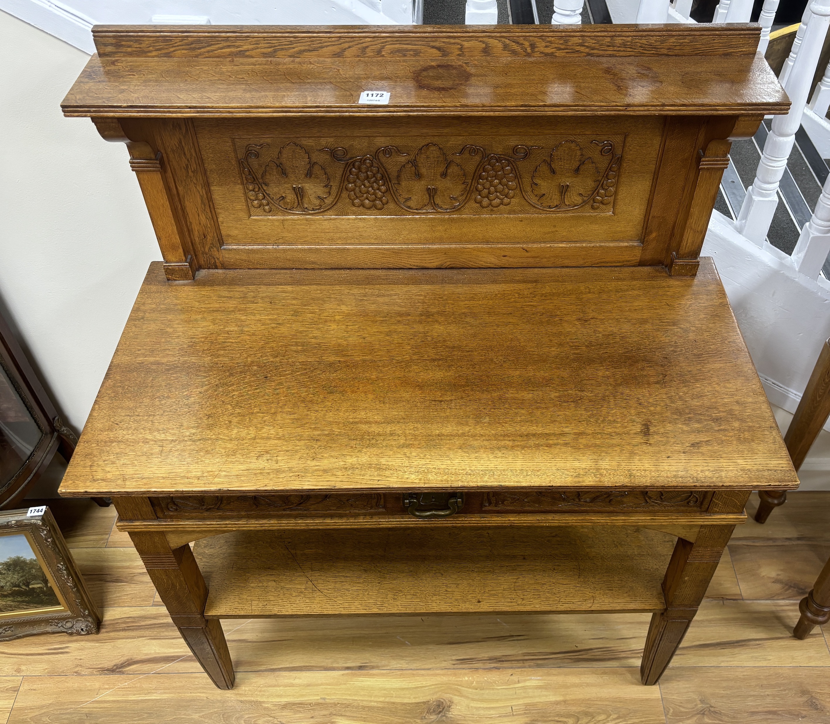 An Arts & Crafts carved oak buffet, width 104cm, depth 52cm, height 123cm